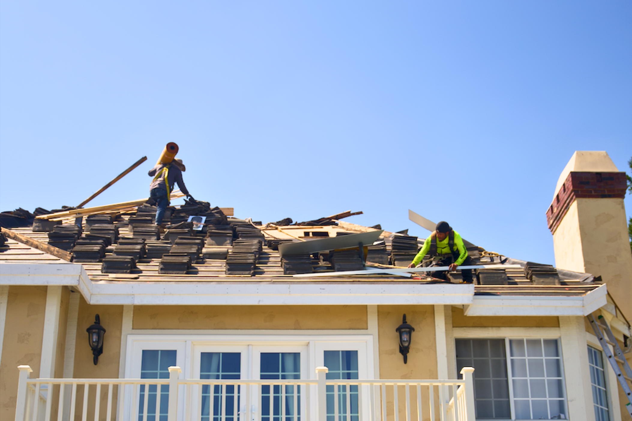 Green Ladder crew re-roofing a tile roof