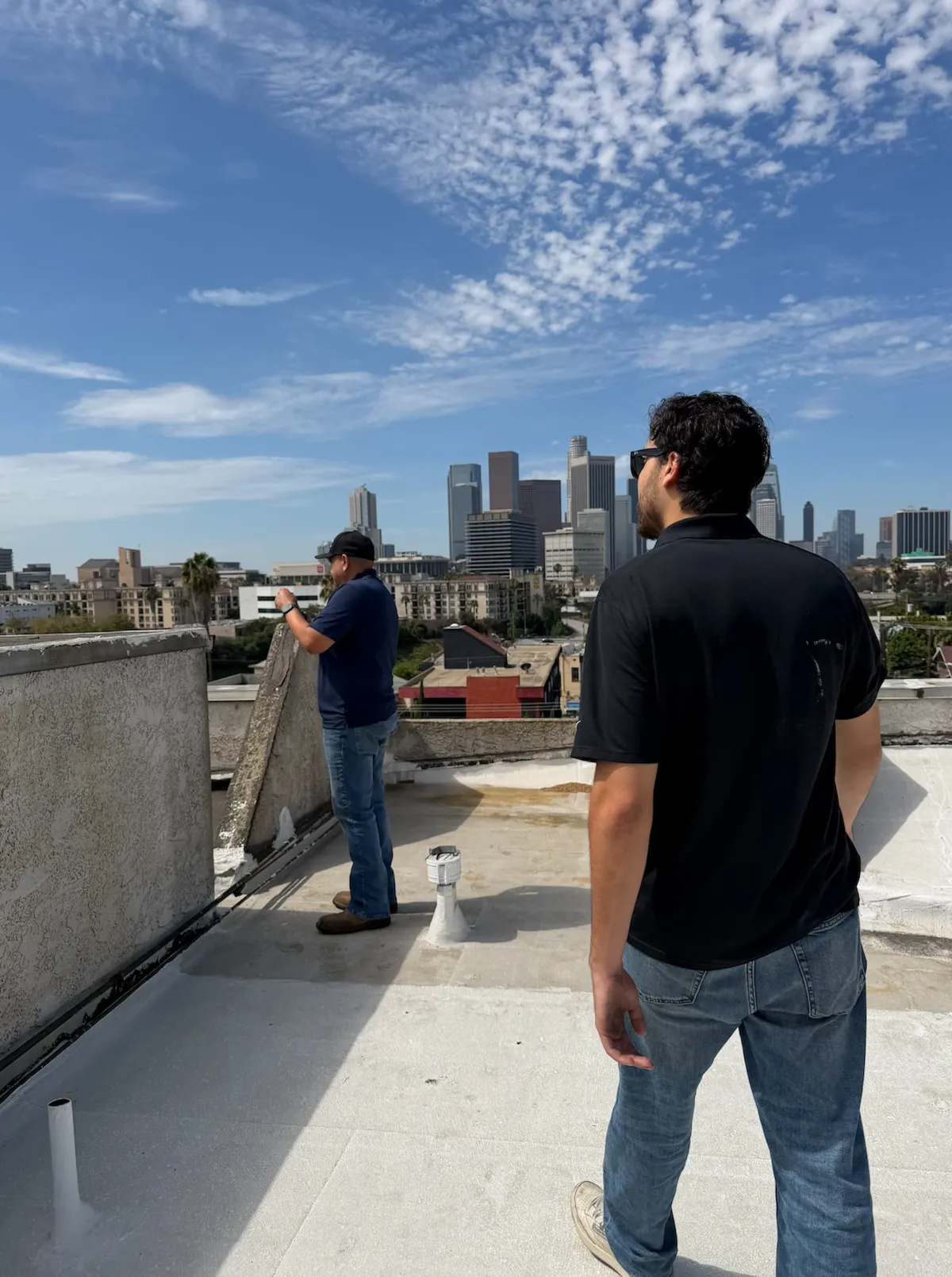 Flat roof inspection on a commercial-style building